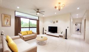 a living room with a couch and a tv at Waterfront Sunset Apartment in Fantasy Island Nadi in Nadi