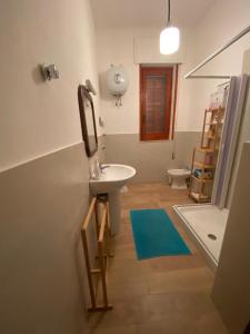 a bathroom with a sink and a toilet at Casa Liliana in Marsala