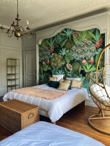 a bedroom with two beds with a floral wall at La maison de famille Limoges in Limoges