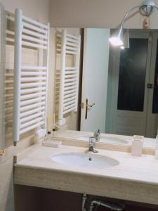 a bathroom with a sink and a mirror at Apto La Almena 2 junto a Plaza Mayor,2 habitaciones,parking gratuito in Cáceres +10 photos
