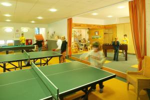 un grupo de personas en una habitación con mesas de ping pong en Feriendorf Reichenbach - Wieselweg 1 en Nesselwang