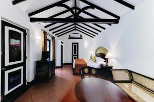 a bedroom with a bed and a table in a room at Cinnamon Lodge Habarana in Habarana