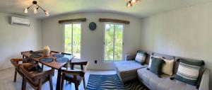 a living room with a couch and a table at CORMORAN COZY CONDO IN IXTAPA in Ixtapa