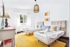 a living room with two beds and a couch at Villa Eva by OCvillas in Albufeira +55 photos