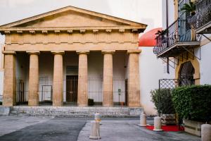an old building with columns and a balcony at Hotel Palazzo Brunaccini in Palermo