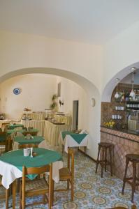 a restaurant with tables and chairs in a room at Hotel Villa Sarah in Capri