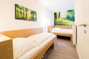 a bedroom with two beds in a room at Sandwig-Lodge in Glücksburg