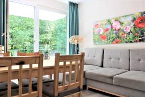 a living room with a couch and a table at Sandwig-Lodge in Glücksburg +13 photos