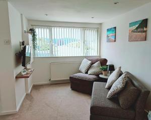 a living room with a couch and a window at *Close to Beach* One Bedroom Suite with Parking in Overstrand