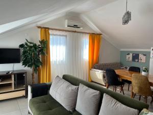 a living room with a couch and a table at kerim apart tatil evleri in Fethiye