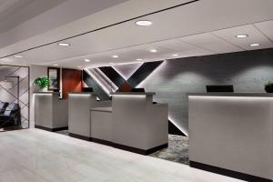 an office lobby with a counter and a staircase at Des Moines Marriott Downtown in Des Moines