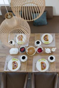 a table with plates of food on top of it at Reetdorf Geltinger Birk Künstlerkate Eisvogel in Nieby