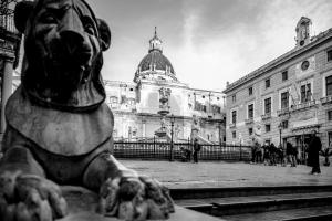 a black and white photo of a building with a statue at Hotel Palazzo Brunaccini in Palermo