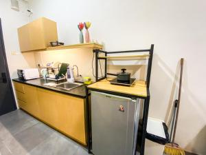 a small kitchen with a sink and a refrigerator at ED Studio 34@DPAC/IKEA/1 Utama/TTDI in Petaling Jaya
