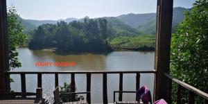 a view of a river from a balcony with a view at Nguyen Shack - Phong Nha Resort in Phong Nha
