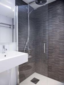 a bathroom with a sink and a glass shower at Radisson Blu Hotel Bodø in Bodø +80 photos