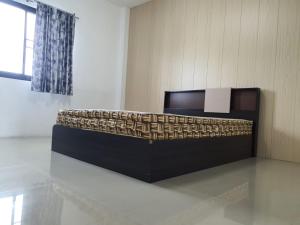 a room with a bed in the middle of a room at Min&Me House Pattaya in Nong Prue