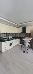 a kitchen with white cabinets and a table and chairs at Apartment in Antalya Konyaaltı in Antalya
