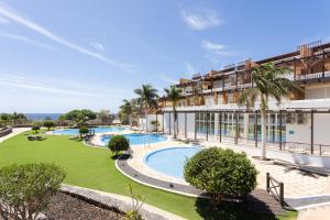 an exterior view of a resort with a swimming pool at Home2Book Stylish Apt Amarilla Golf, Pool&Terrace in San Miguel de Abona