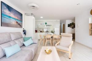 a living room with a couch and a table at Home2Book Stylish Apt Amarilla Golf, Pool&Terrace in San Miguel de Abona