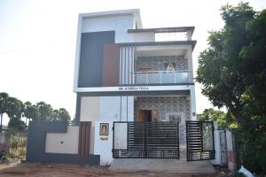 a white house with a gate in front of it at Private 4 BHK Villa with WiFi, Swimming Pool, BBQ in Chennai