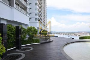 a walkway in front of a building with a swimming pool at Maxhome at Silverscape Residence Melaka in Malacca +7 photos