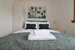 a bedroom with a bed with a white pillow on it at Signature - Binnie House in Cumbernauld