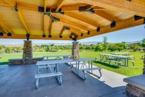 a group of picnic tables under a wooden roof at Boise Townhome with Rooftop Deck, 2 Mi to Downtown! in Boise