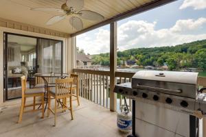 a patio with a grill and a table on a balcony at Community Pool Lakefront Osage Beach Condo! in Osage Beach