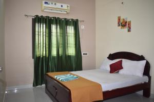 a bedroom with a bed with a green curtain at Private 4 BHK Villa with WiFi, Swimming Pool, BBQ in Chennai
