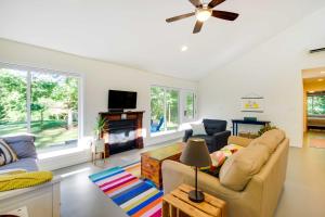 a living room with a couch and a tv at Quaint Charlottesville Home Less Than 10 Mi to Dtwn! in Earlysville