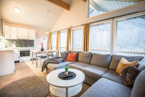 a living room with a couch and a table at Tromsø Lodge & Camping in Tromsø