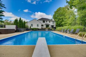 a swimming pool in front of a house at Luxury Maineville Villa with Private Pool and Deck in Maineville