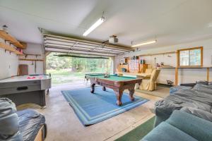 a living room with a pool table in it at Houghton Lake Area Home with Fire Pit and Yard! in Houghton Lake
