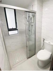 a white bathroom with a shower and a toilet at SEAVIEW FULL FURNISHED # FORESTCITY # Free WiFi in Kampong Pok Kechil