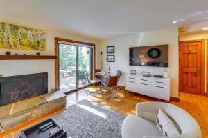 a living room with a fireplace and a table at All-Season Sun Valley Retreat with Deck and Grill in Sun Valley