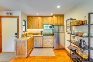 a kitchen with wooden cabinets and a stainless steel refrigerator at All-Season Sun Valley Retreat with Deck and Grill in Sun Valley