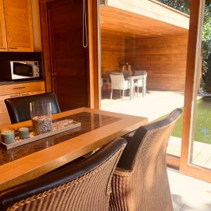 a wooden table with two chairs and a dining room at Casa Mateo 