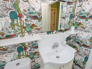 a bathroom with a sink and a mirror at Garstons Barn in Newport +36 photos