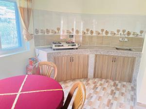 a kitchen with a table and a counter top at Prashiddha Resort in Dakshīnkāli