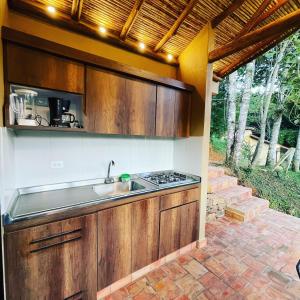 a kitchen with a sink and a counter top at Hotel Casas de Campo El Ciruelo in San Gil