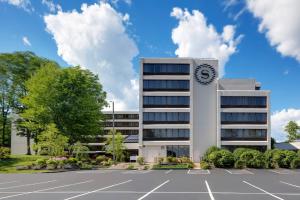 a building with a clock on the side of it at Portland Sheraton at Sable Oaks in South Portland