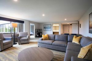 a living room with a couch and chairs and a table at Portland Sheraton at Sable Oaks in South Portland