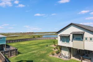 an aerial view of a house with a yard at Beach Please in Port Aransas