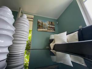 a room with a stack of white pillows and a couch at Casa Bella in Weinheim