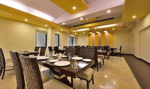 a dining room with a table and chairs in a room at FabHotel Prime The Western in New Delhi
