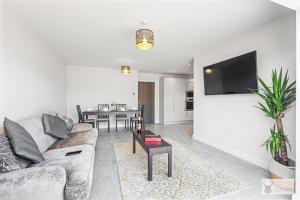 a living room with a couch and a table at Elegant 5-Bed House with ample parking in Smisby