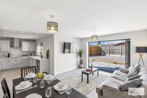 a living room with a couch and a table at Elegant 5-Bed House with ample parking in Smisby