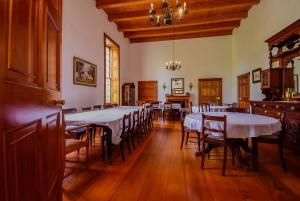 a dining room with tables and chairs and a chandelier at Heins Manor House in Stellenbosch