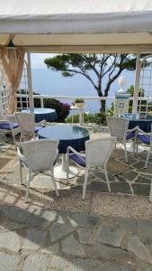a group of chairs and a blue table and chairs at bb la guardiia in Anacapri